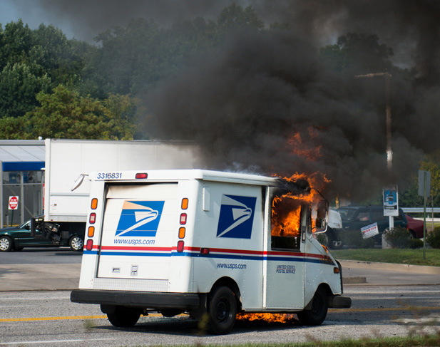 Photos taken around 5:00 PM on Red Run blvd in Owings Mills of a Mail Truck on fire outside the Royal Farms Gas Station on the corner of Red Run Blvd and Pleasant Hill Road